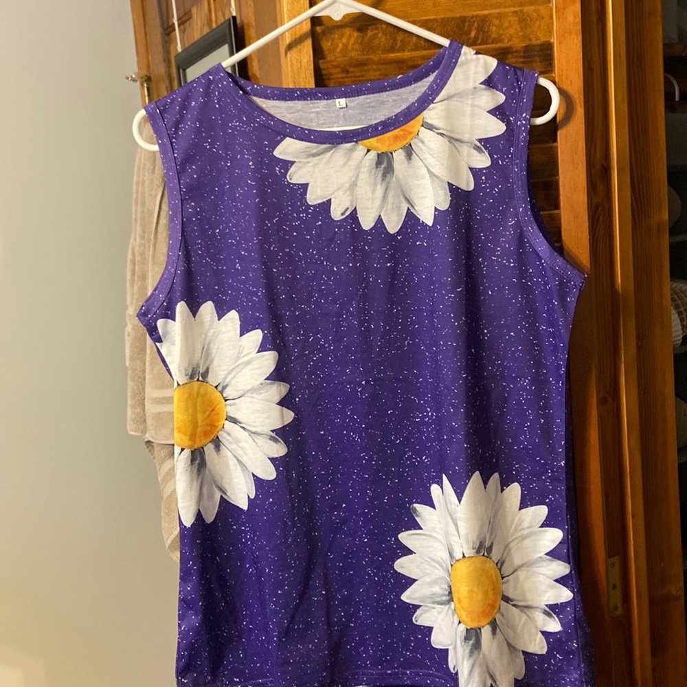 Purple top with white flowers. Soft texture. Never worn.
